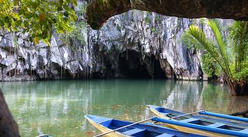 Puerto Princesa Underground River entrance with tour boats in the foreground.