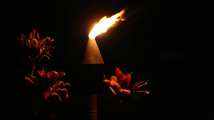 5 day Maui itinerary - A flame at a luau in Maui at night, Hawaii, USA