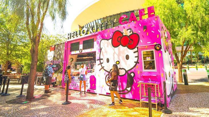 A pink food truck-style cafe with Hello Kitty on it