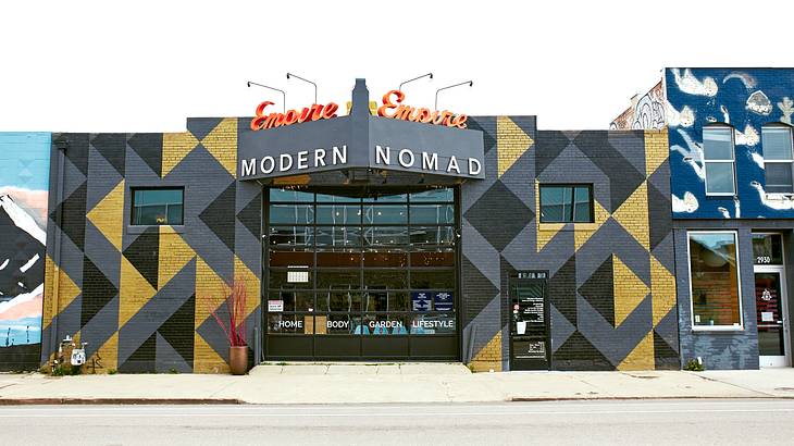 A storefront with a black, gold, and grey pattern painted on it