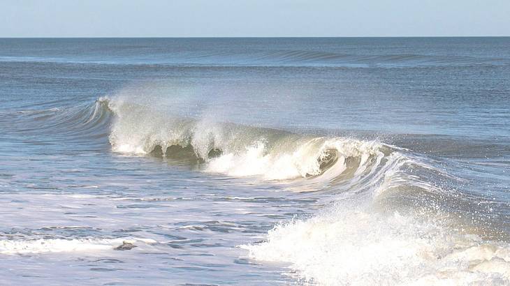 Waves crashing in the ocean with a clear sky above Waves crashing in the ocean with a clear sky above