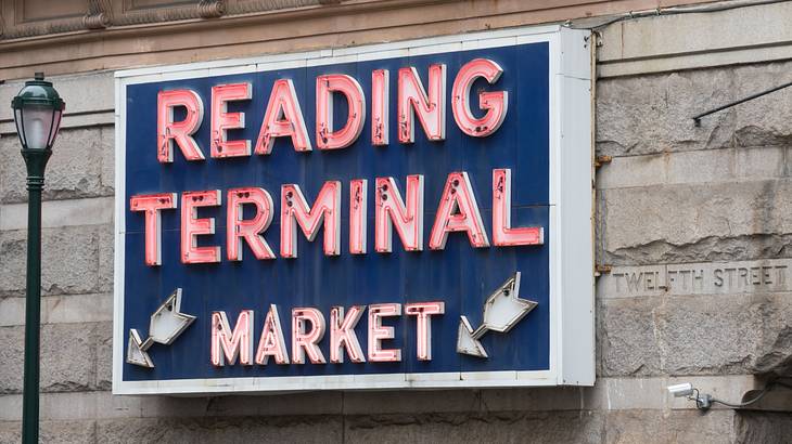 A blue sign that says "Reading Terminal Market" in red