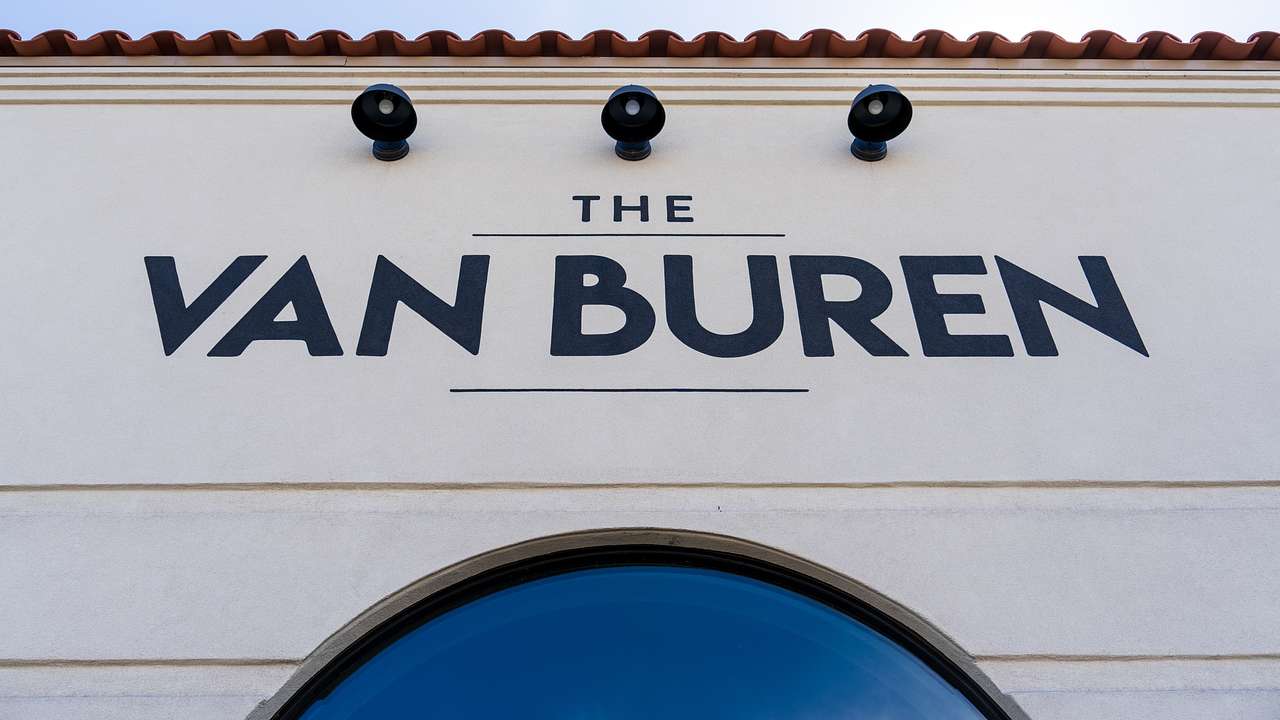 Blue painted letters on the wall of a building saying "Van Buren"