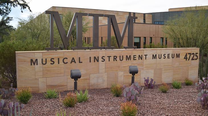 Signage saying "MIM, Musical Instrument Museum 4725" with a building at the back