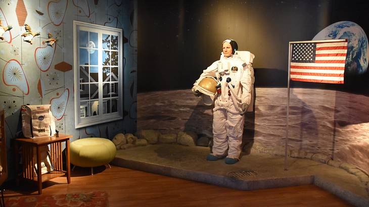 A wax figure of an astronaut with an American flag