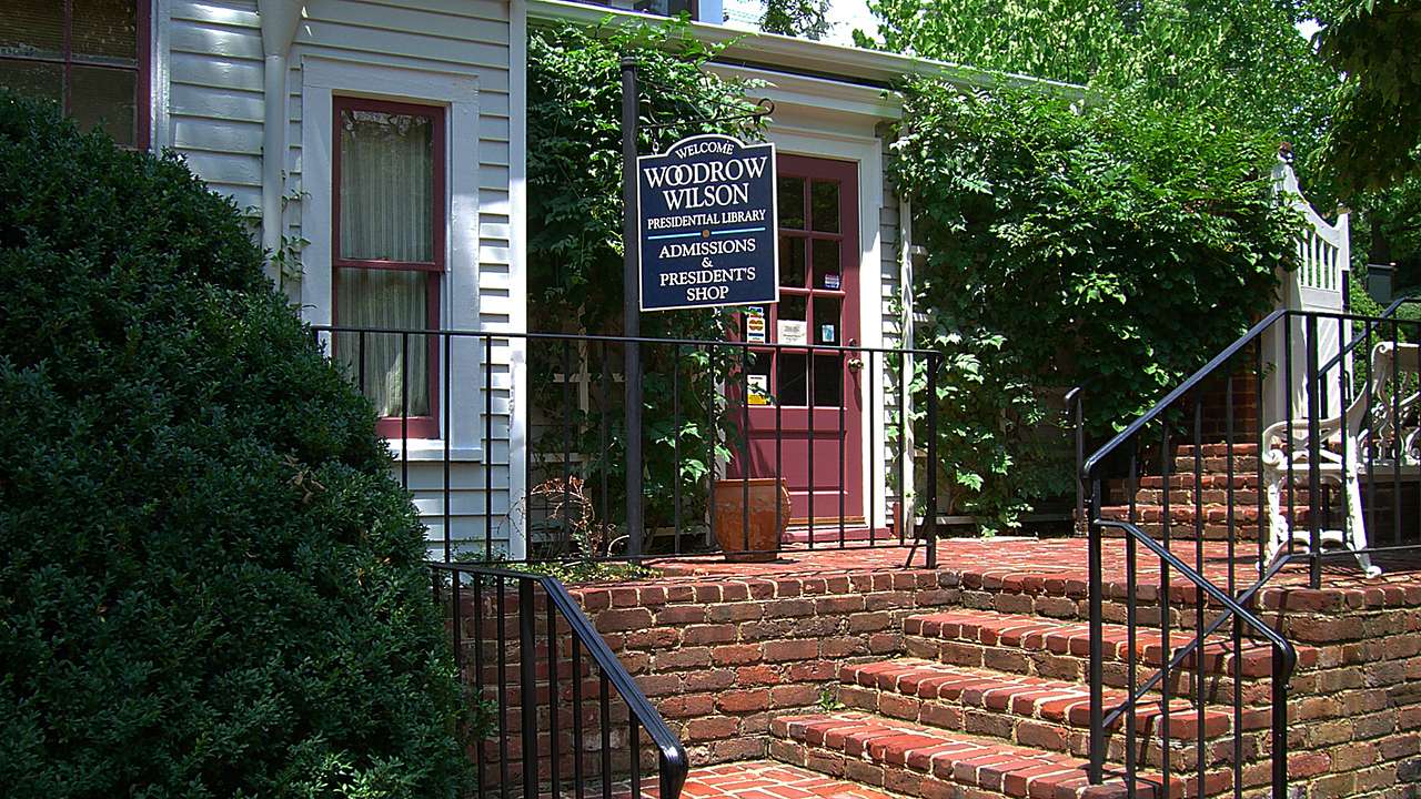 Brick steps leading to a door of a building with a "Woodrow Wilson" sign