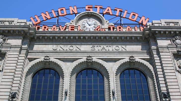 A stone building with a "Union Station" sign and large arched windows