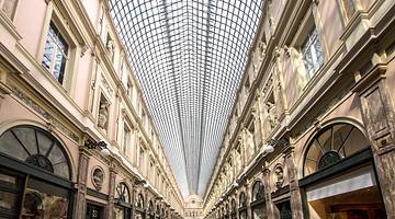 The glass panels of a shopping mall rooftop from below
