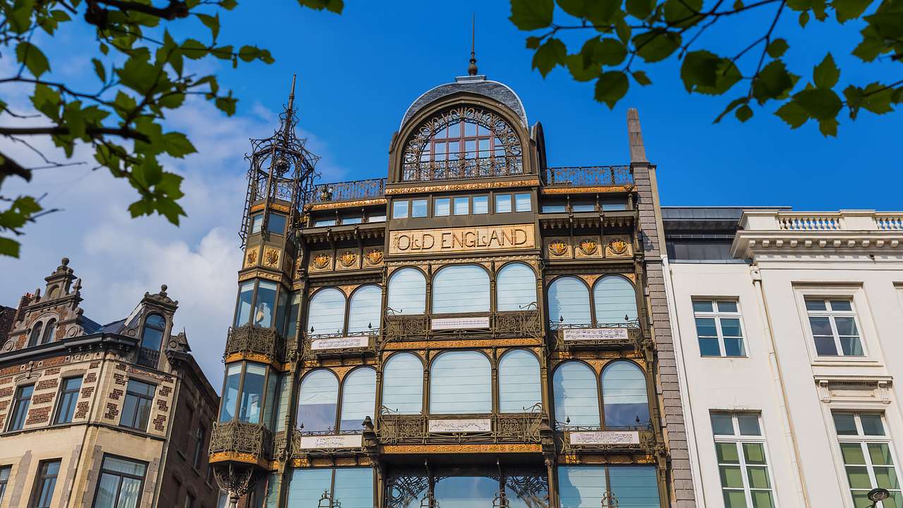 A black and gold Art Nouveau building with arched glass windows