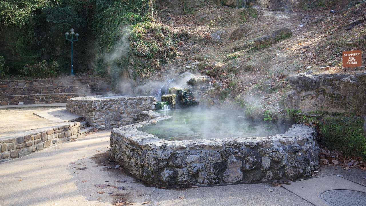 White steam rising from a hot water pool