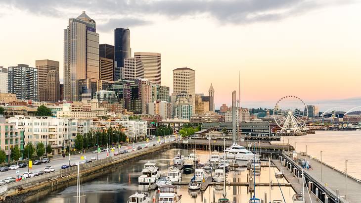 City skyline of tall and short buildings with cars and a harbor with yachts nearby