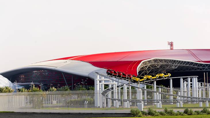 Ferrari world building featuring a rollercoaster enclosed within a steel fence