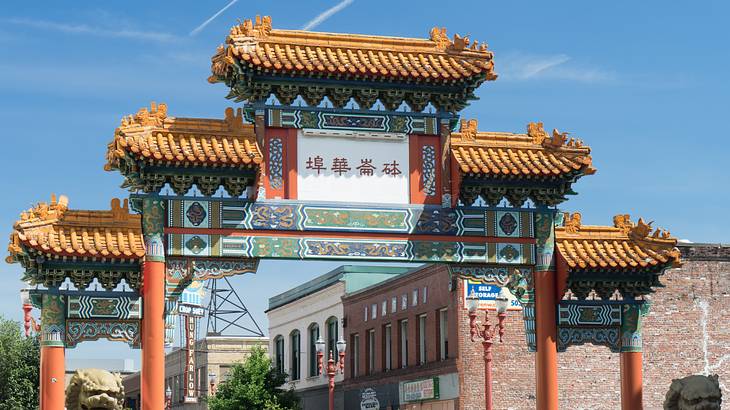A traditional Chinese-style arch next to buildings A traditional Chinese-style arch next to buildings