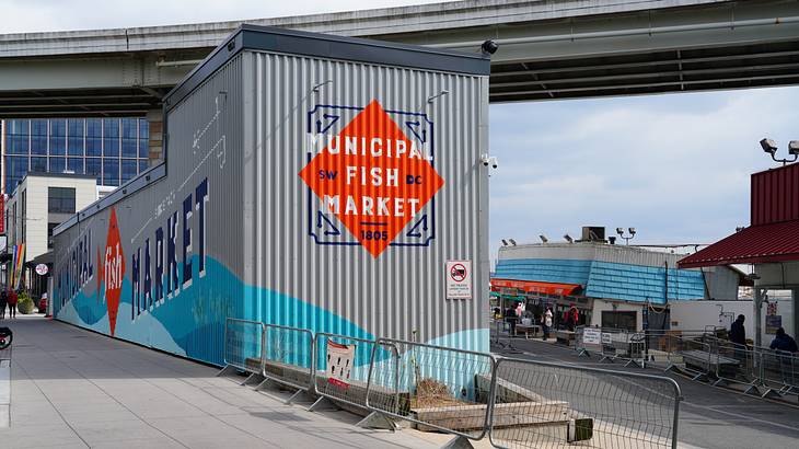 A container van with graffiti art that says "Municipal Fish Market"