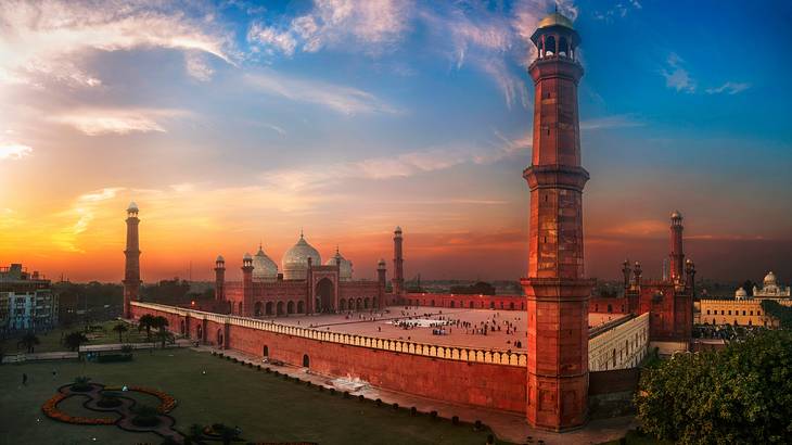 The outside architecture of a beautiful mosque and its massive compound from above