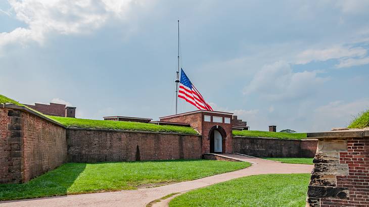 A brick structure with an American flag on top