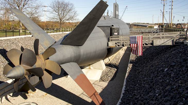 View of the backside of a submarine docked in a ditch on a clear day