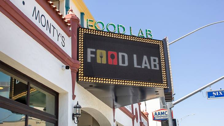 A sign that says "Food Lab" next to a white building with a "Monty's" sign