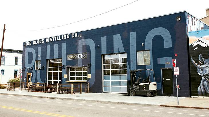 A blue building with "The Block Distilling Co." painted on it