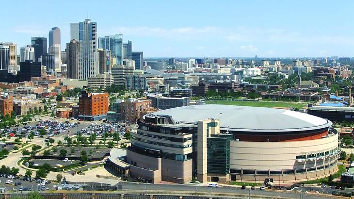 A stadium with a skyline in the background under a blue sky