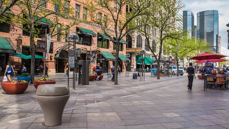 A pedestrian square with buildings and patio cafes