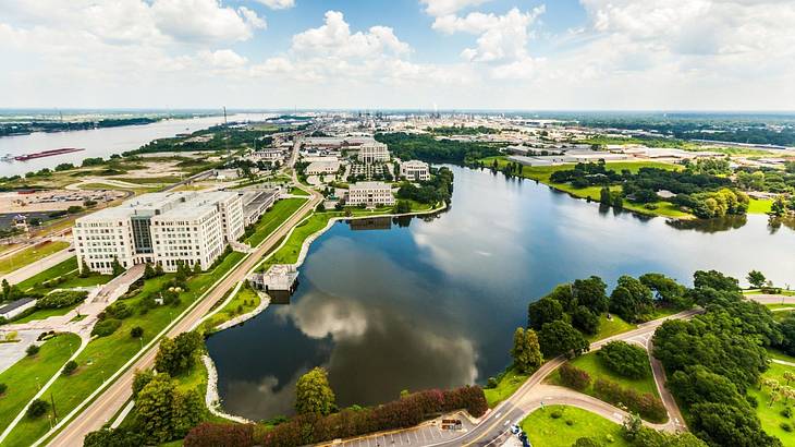 A view over a river with greenery and buildings around it