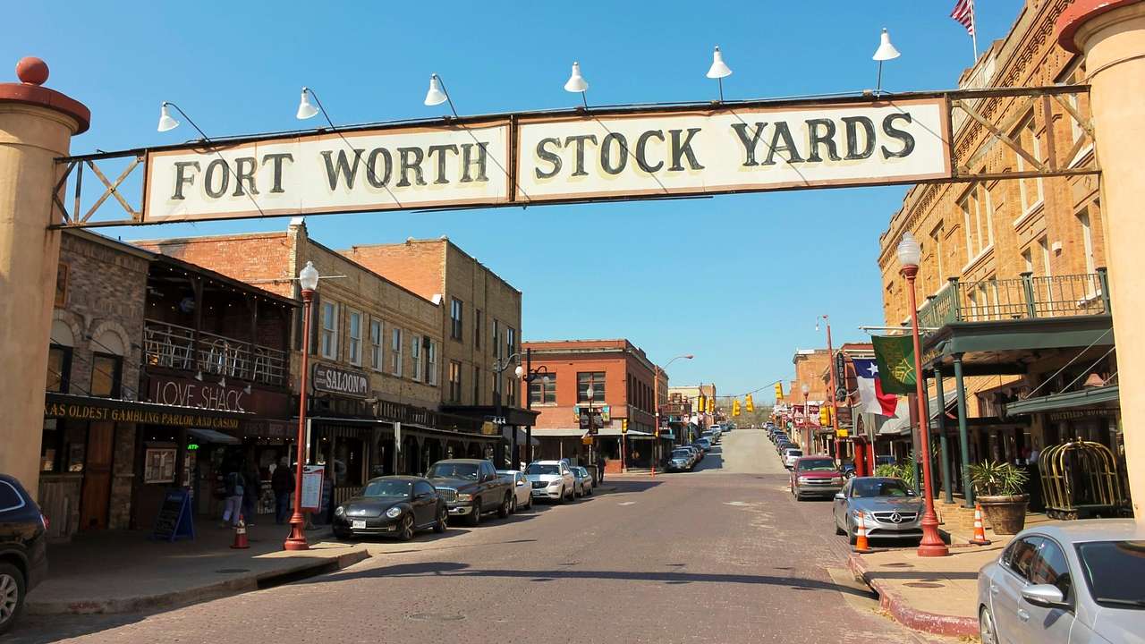 A sign over a street that says "Fort Worth Stock Yards"
