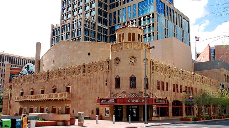 A brown Baroque Revival structure with a red sign of "ORPHEUM" above the door