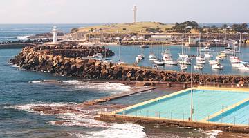 View of pools, water, a marina with boats and rocks, Wollongong, NSW, Australia