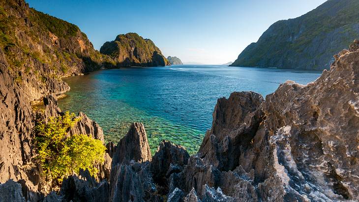 A blue lagoon surrounded by tall rocks, Secret Lagoon, Palawan, Philippines