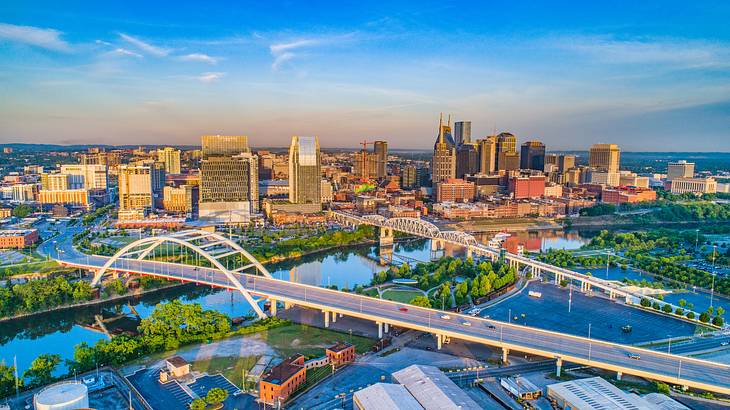 Aerial view of a city with a bridge, river, and skyscrapers