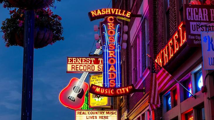 A building with neon signs on it that are illuminated at night