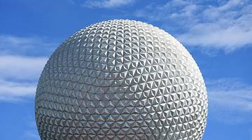 A white golf ball-shaped structure with blue sky in the background