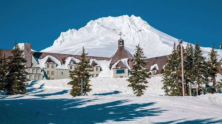 A Cascadian-style lodge at the foot of a snow-covered mountain