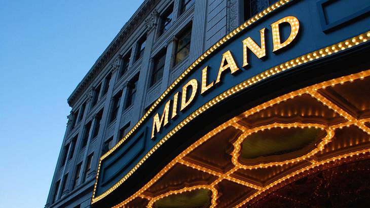 A building with a black awning and an illuminated sign that says "Midland"