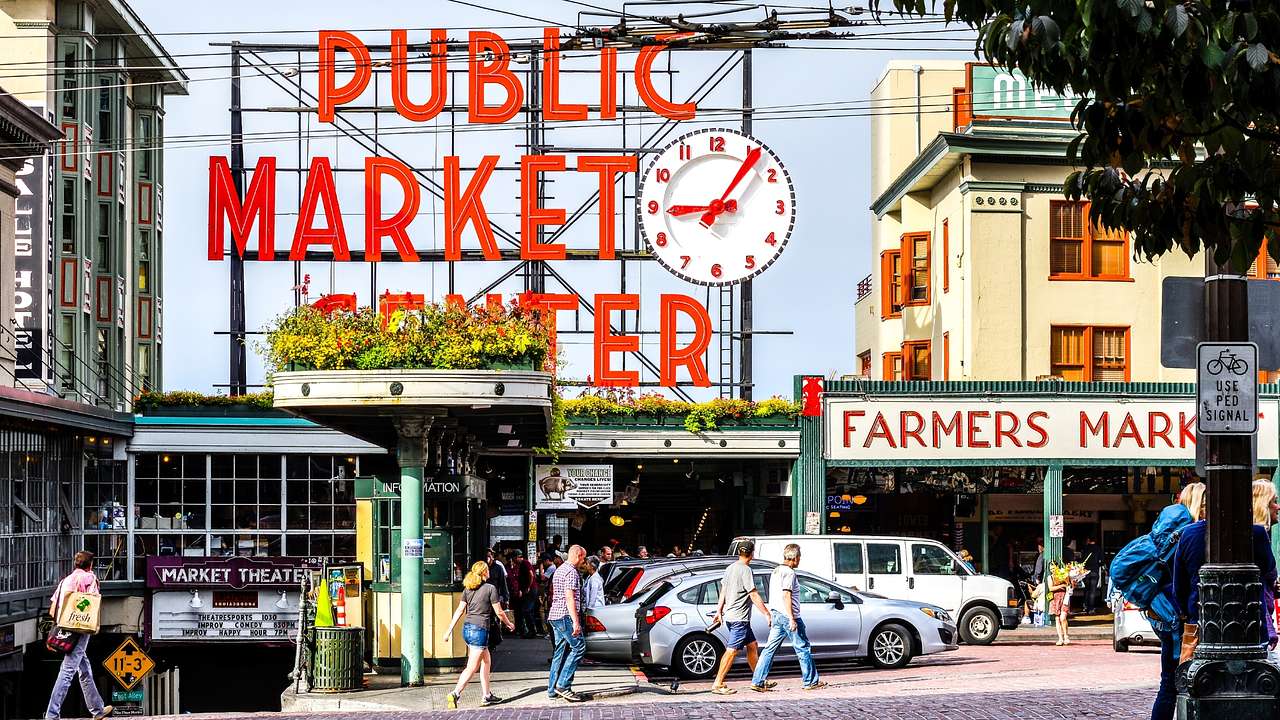A big "Public Market Center" red sign next to a street with people and cars
