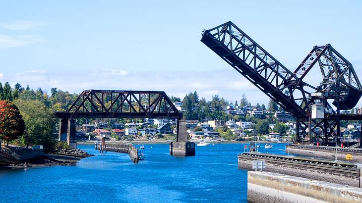 A body of water with bridges over it under a blue sky