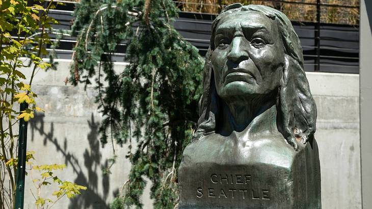 An oxidized copper bust of a Native American chief engraved with "Chief Seattle"