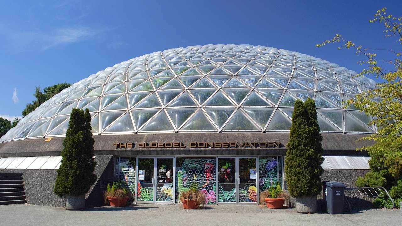 A building with a glass dome and a sign that says "The Bloedel Conservatory"