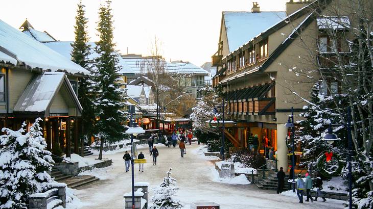 A snowy ski village under a white sky