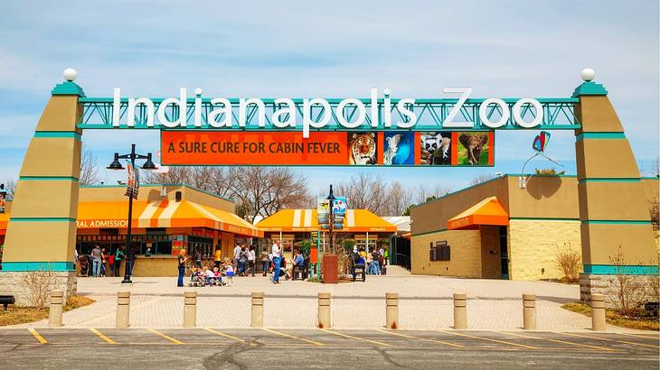 An entrance gate with a sign that says "Indianapolis Zoo"