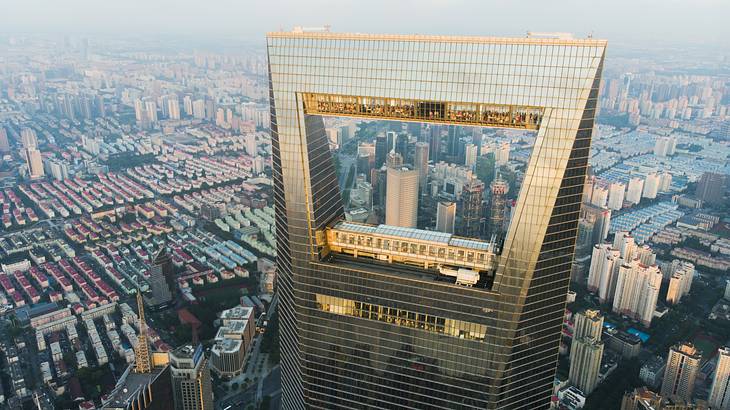 The top of a skyscraper with an observation deck and the city down below