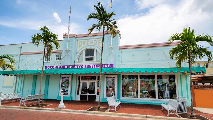 An aquamarine building with a sign saying Florida Repertory Theatre