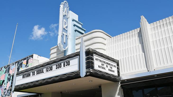 An Art Deco-style theater facade on a sunny day