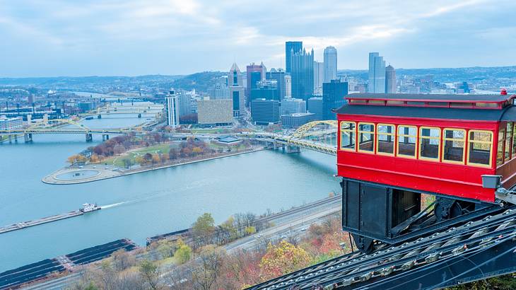 An inclined funicular railway with a cityscape in the background