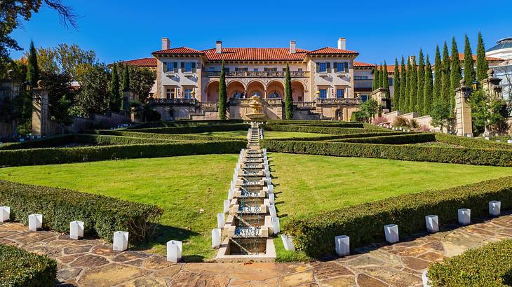 A Renaissance-style villa with a vast landscaped garden in front
