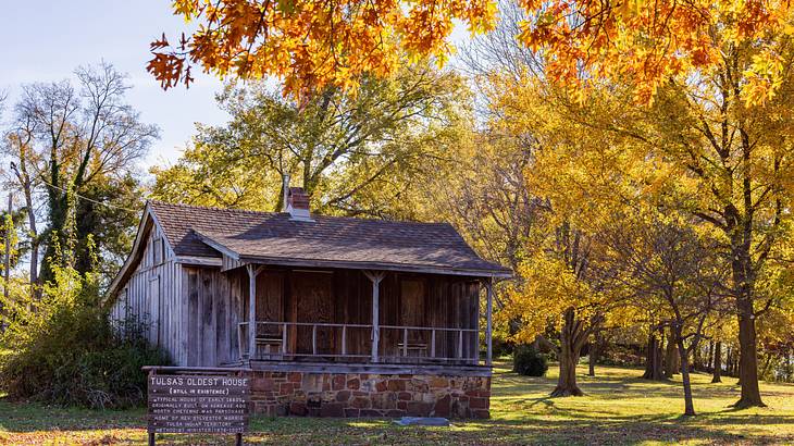 An old wooden house surrounded by trees in fall