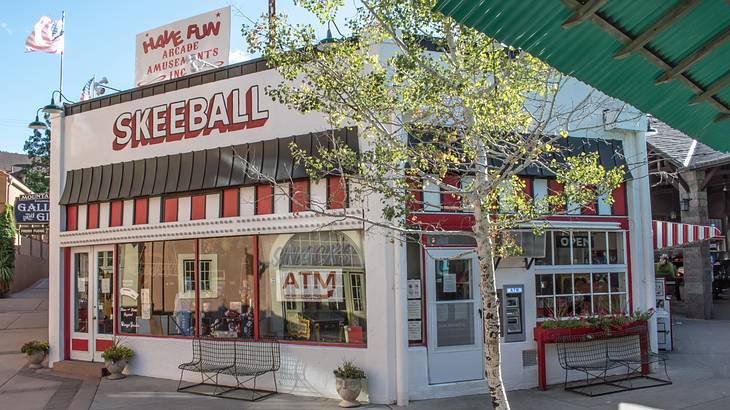 A small white and red building with a sign that says "Skeeball"