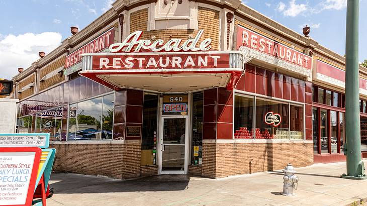 The front of a diner-style restaurant with a sign that says "Arcade Restaurant" The front of a diner-style restaurant with a sign that says "Arcade Restaurant"