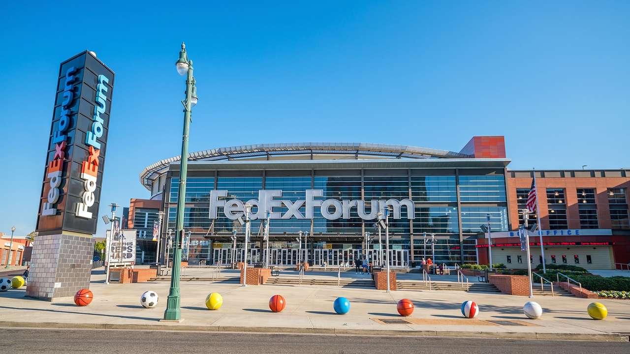 A sports venue with signs that say "FedExForum" with colored balls in front